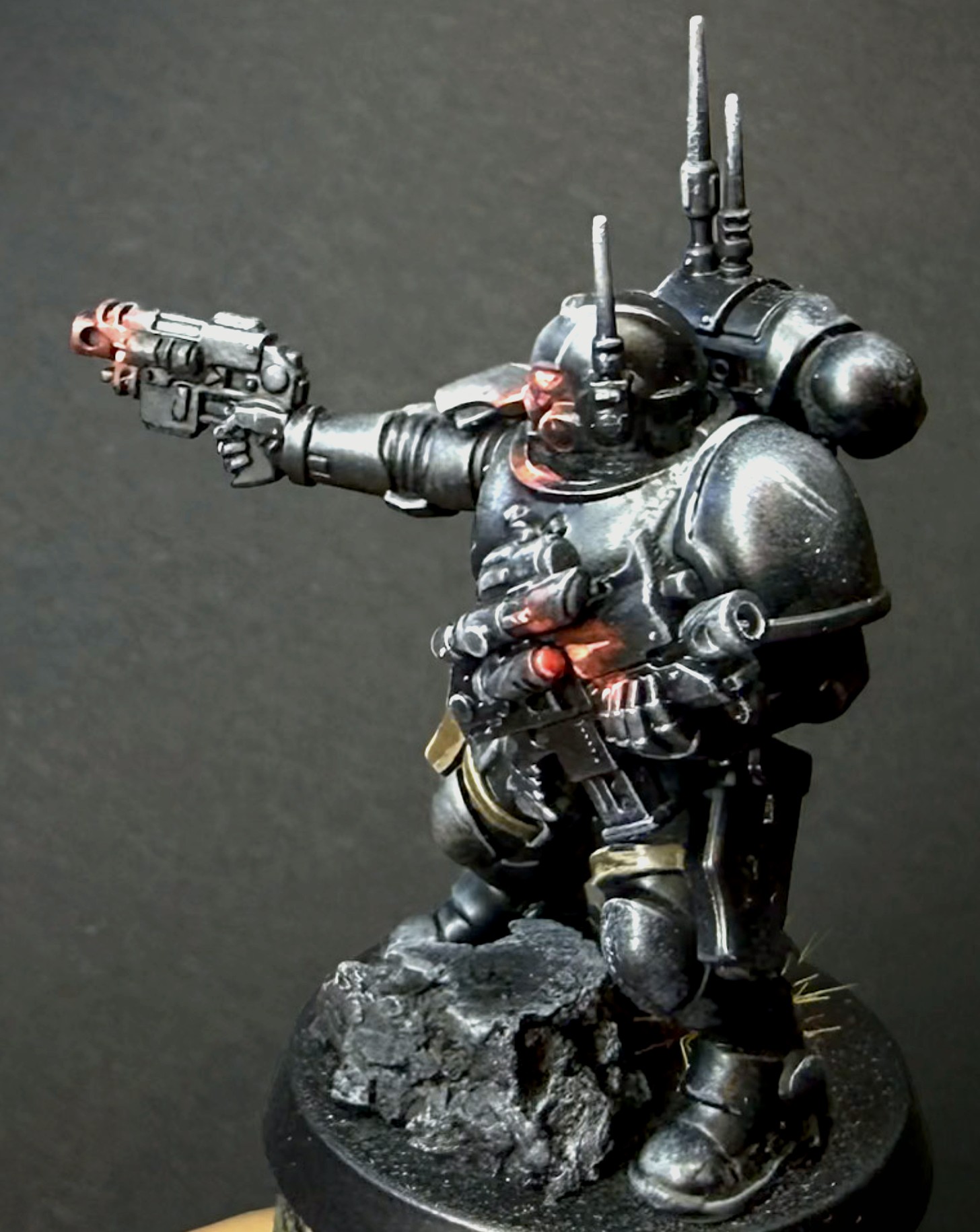 Painted black armoured Infiltrator with glowing red visor and twin pistols raised